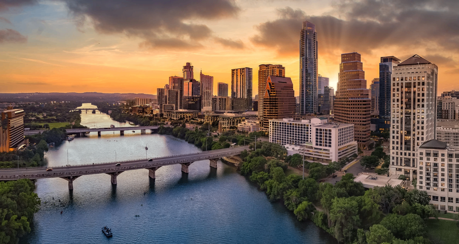 Austin Texas skyline at sunset with Lady Bird Lake and Congress Avenue Bridge