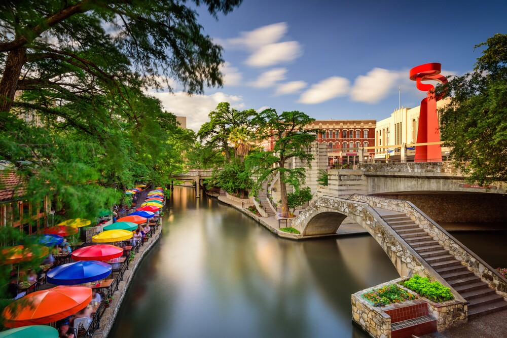 San Antonio River Walk with colorful umbrellas and historic architecture